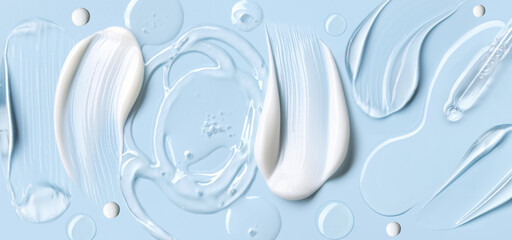 samples of cosmetic care products smear of cream and gel texture on a light blue background,...