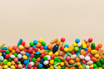 Mixed collection of colorful candy, on colored background. Flat lay, top view. frame of colorful chocolate coated candy