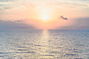 Beautiful orange sunrise sky over the sea horizon. Summer golden hour.