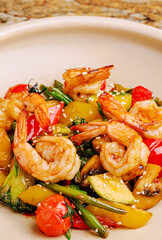 Colorful shrimp stir-fry with fresh vegetables and sesame seeds served in a bowl