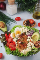 A bowl with cobb salad, traditional American dish