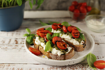 Italian sandwiches with grilled tomatoes, burrata cheese and pesto	