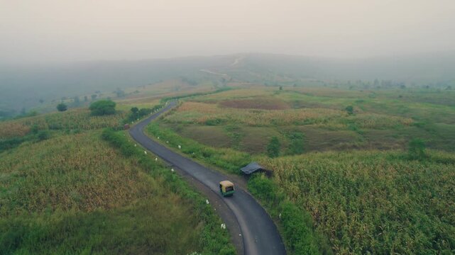 Aerial View of Auto Rickshaw Traveling Toward Jagmer Hills During Monsoon in Banswara, Rajasthan, India