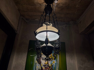 Elegant vintage chandelier illuminates modern art in dimly lit interior for sophisticated design concepts and artistic inspiration