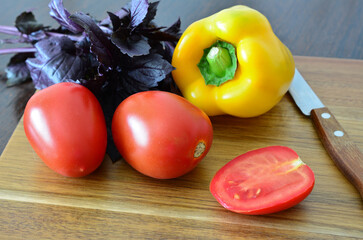 cooking with Fresh Vegetables and Herbs on a Wooden Cutting Board