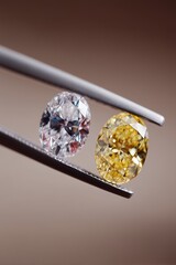 Close-up image of a yellow and a clear diamond held by tweezers, showcasing their exquisite facets and brilliance.
