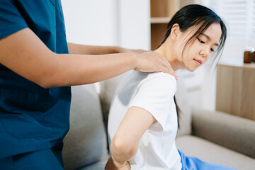 Fototapeta premium Healthcare professional providing back physiotherapy and pain relief treatment, showing patient recovery, rehabilitation, and physical therapy care support.