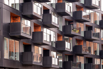 Modular architecture featuring apartment facade volumes and bold balconies forming a modern urban look in copenhagen denmark with a striking geometric pattern