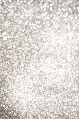 Silver Sparkling Lights Festive background with texture. Abstract Christmas twinkled bright bokeh defocused and Falling stars.
