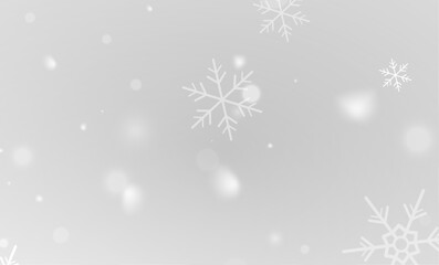 Shimmering white snowflakes falling softly on transparent winter sky
