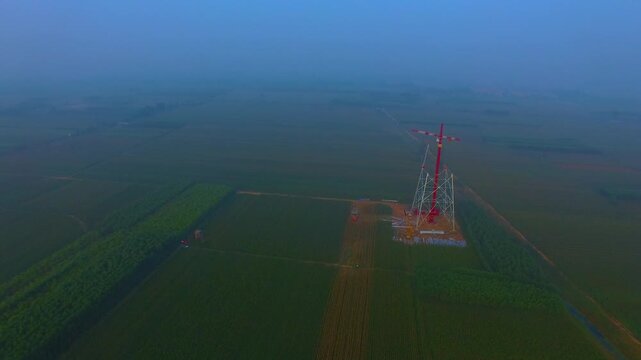 High-Voltage Tower in Rural Agricultural Landscape - Aerial View