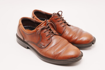 Brown leather shoes showing signs of age and wear