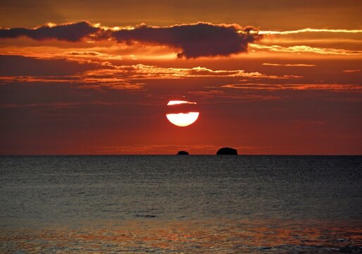    fiery sunset over the  pacific ocean  and catalinas islands from sugar beach resort at playa azucar cove, near playa flamingo, costa rica 