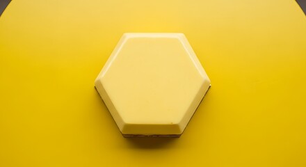 Close-up shot of a yellow hexagon shape on a matching yellow background, showing the object's form.