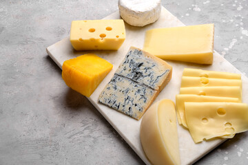 Gourmet cheese platter with craft cheese assortment on a marble platter. hard cheeses, mold cheese, gorgonzola, pecorino, Emmental, Roquefort ,  cheddar