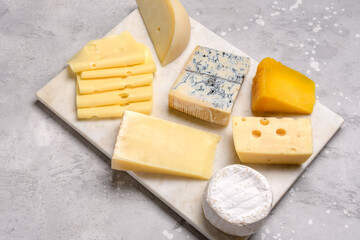 Gourmet cheese platter with craft cheese assortment on a marble platter. hard cheeses, mold cheese, gorgonzola, pecorino, Emmental, Roquefort ,  cheddar