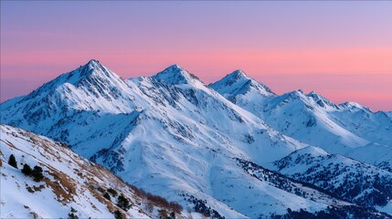 Stunning view of snow-covered mountain peaks during sunset, showcasing vibrant colors in the sky. Ideal for nature and travel themes.