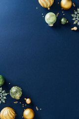 Luxury gold and green Christmas decorations on dark blue background. Xmas vertical banner template, Happy New Year poster mockup.