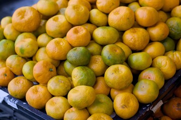 Close up view of ripe mandarins with vibrant texture and natural color, capturing freshness and organic appeal for food, health, and market themes.