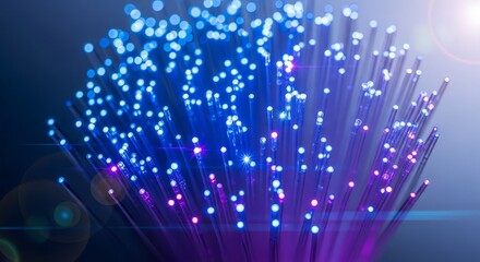 Close up of a bundle of fiber optic cables glowing with blue and purple light on a dark background