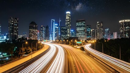City skyline at night with light trails on highway and stars, long exposure showing movement in urban transportation - Powered by Adobe