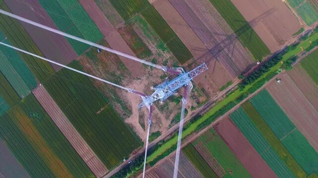 High Voltage Power Tower Aerial View Over Agricultural Fields