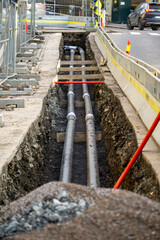 Utility Trench Excavation and Pipe Installation in City Street - Urban Infrastructure Construction Site