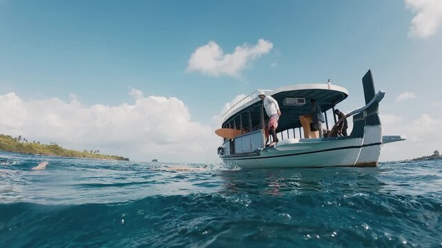 Surfer jumps from taxi surfing boat into the sea