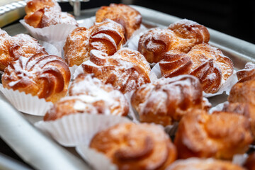 tray of delicious sweet cream puffs at a business event