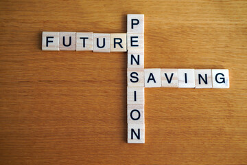 future, pension, and savings. financial concepts. words written in wooden letters like a crossword puzzle