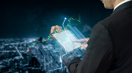 A businessman interacts with a tablet displaying stock market graphics and data analysis, symbolizing technological advancements in finance and investment strategies in an urban setting. Scalp