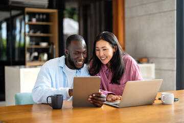 Online entertainment and social media. Diverse, multiethnic couple enjoying the digital world