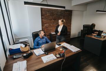 Three business colleagues collaborate in a contemporary office setting, enhancing productivity and teamwork.