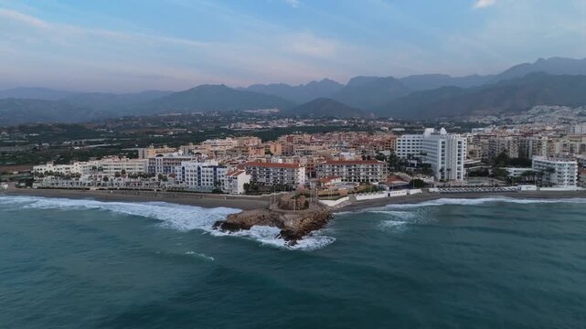Aerial Drone POV of Nerja coastal town, which is a municipality on the Costa del Sol in the province of Malaga in the autonomous community of Andalusia in southern Spain.