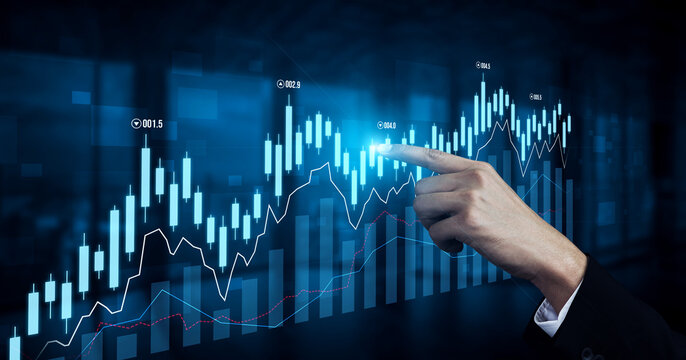 A businessman points at a digital stock market graph showing an upward trend. This image represents investment growth and financial analysis in a modern setting. Scalp