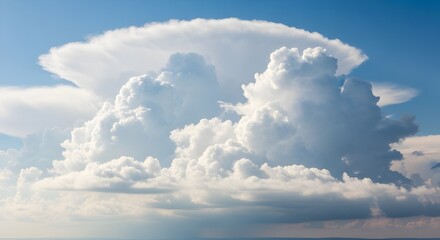 Expansive cumulus cloud formation under blue sky featuring a flat anvil top