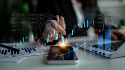 A business professional engages with financial market data using a smartphone and laptop, highlighting modern investment strategies and digital analysis tools. Scalp
