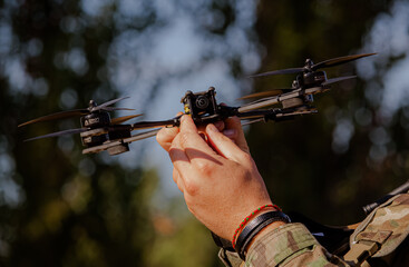 military man holding an fpv drone