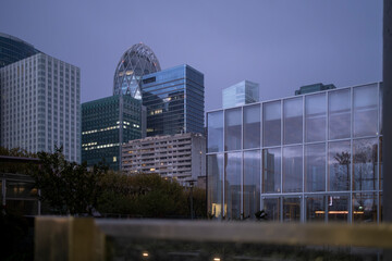 Urban landscape and architecture highlighting diagonal contrast with skyscrapers and reflection on glass shaping the cityscape of the financial district in La Defense in Paris