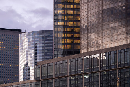 Finance and architecture generating layered reflection on glass as skyscrapers extend through a dense cityscape with contrast in the urban landscape of the financial district in La Defense in Paris