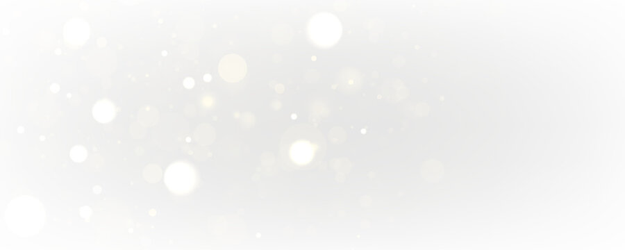 White sparks and stars glitter with soft golden glow on a transparent background. Magical sparkling dust particles create an elegant festive design for Christmas and winter holidays.