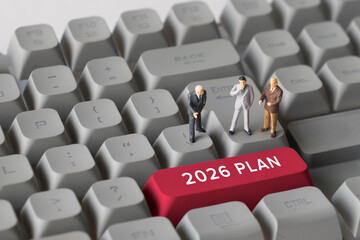 Miniature Business People Standing on Keyboard Button with Text 2026. Representing future planning, business goals, long-term strategy, corporate decision making, and vision for the year 2026.