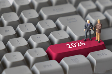 Miniature Business People on Keyboard Button with Text 2026. Representing future planning, business goals, annual strategy, and long-term vision.