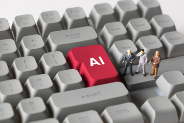 Miniature Business Figures Standing on Keyboard Button with Text AI. Symbolizing artificial intelligence, digital transformation, automation, and future business technology.