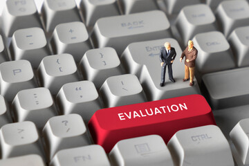 Miniature Business Figure Standing on Keyboard Button with Text Evaluation. Symbolizing performance review, assessment, progress tracking, and business decision-making.