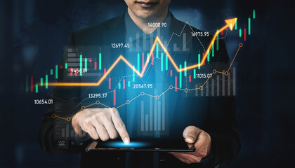 A professional businessman interacts with a tablet, analyzing upward financial trends displayed through various charts and data, highlighting market dynamics and growth potential. Scalp