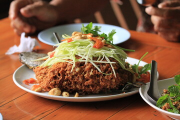 Crispy fried fish with green papaya salad, Thai food