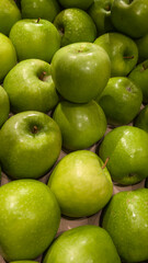 Fresh green apples stacked in a produce display