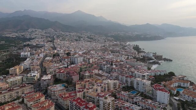 Aerial Drone POV of Nerja coastal town, which is a municipality on the Costa del Sol in the province of Malaga in the autonomous community of Andalusia in southern Spain.