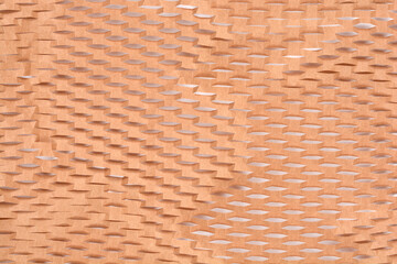 A close-up shot shows the texture of brown packing paper cut into an expandable honeycomb pattern for cushioning